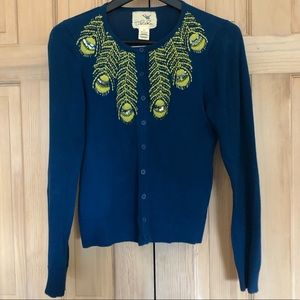 Blue cardigan with neon embroidered feathers